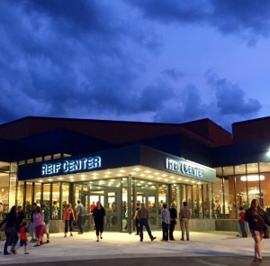 Reif Performing Arts Center in summer with many people outside.